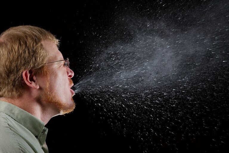 A man mid-sneeze.