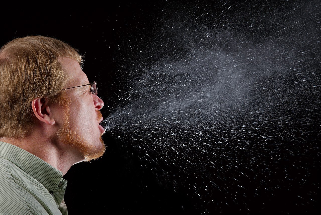 A man mid-sneeze.