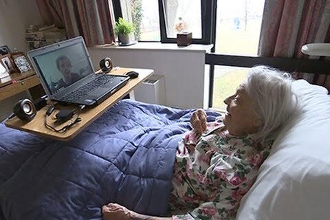 Elderly woman with dementia watching daughter on a laptop