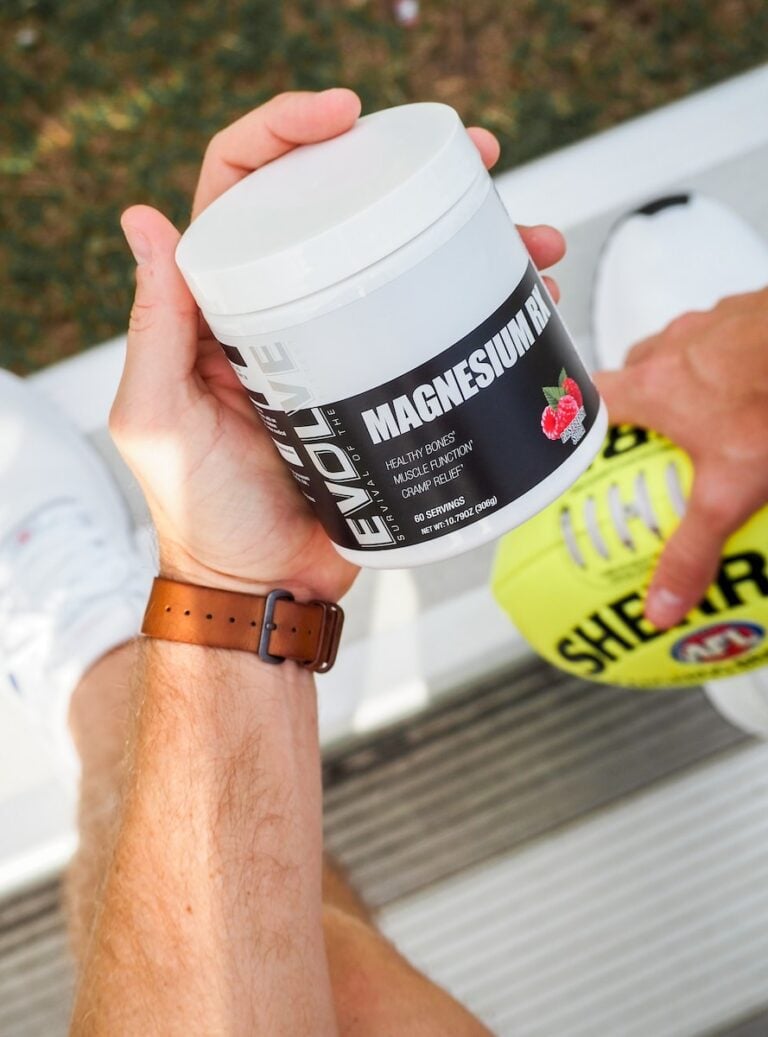 a man holding a jar of vitamin supplement
