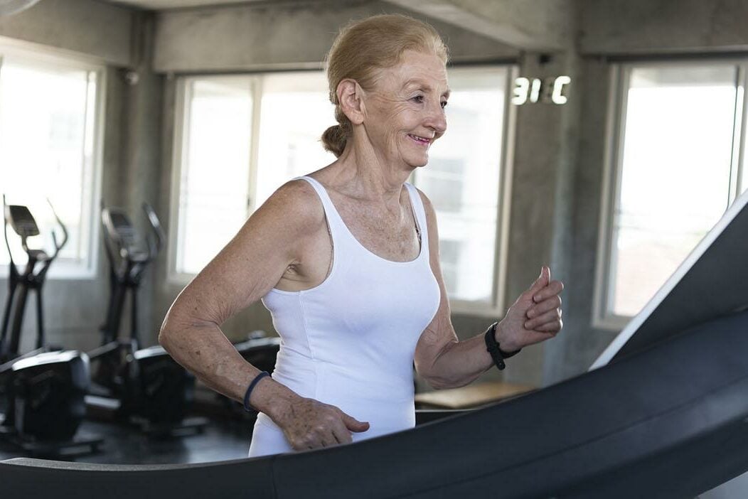 Elder woman exercising on treadmill