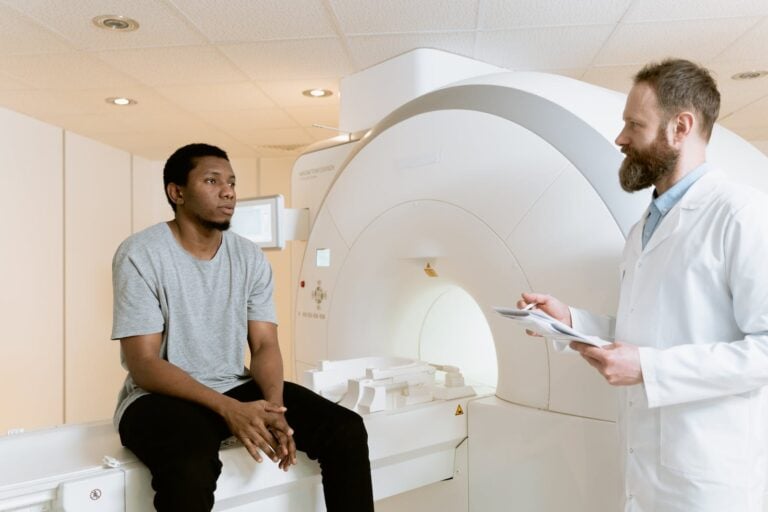 Photo Of Man Sitting On A PET Scanner