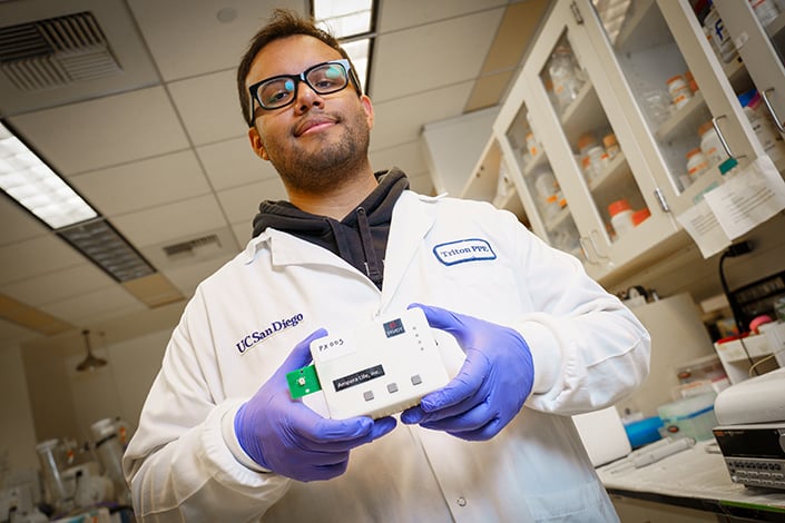 Bioengineering senior Armando Ramil holds the biosensor.
