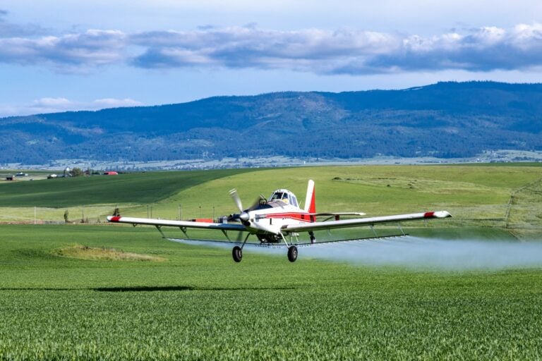 small airplane spreading pesticide