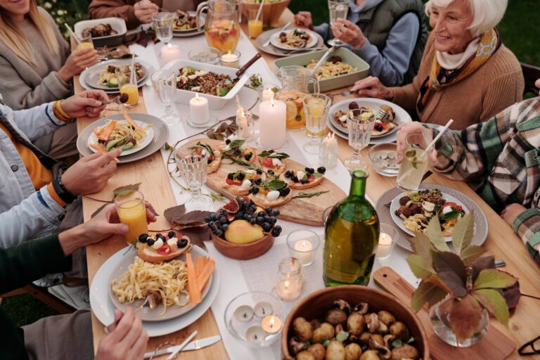 people enjoying festive dinner with candles burning