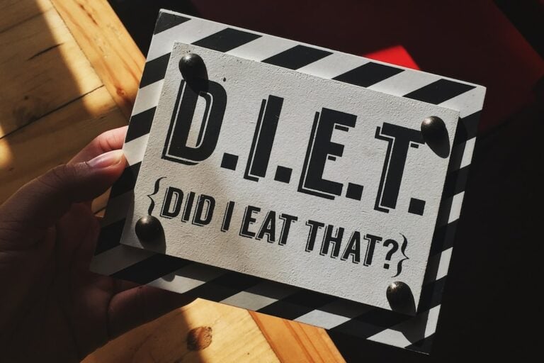 person holding DIET quote board