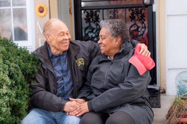 Person with dementia and partner on door step