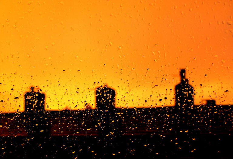 City sunset through raindrops