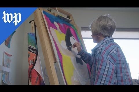 Rebecca painting her artwork