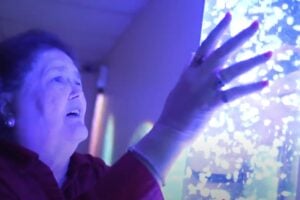 Lady with dementia using a Snoezelen device
