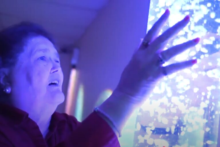 Lady with dementia using a Snoezelen device