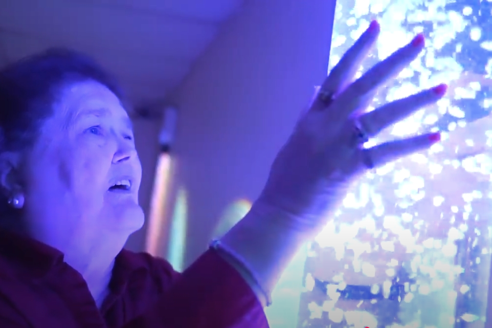 Lady with dementia using a Snoezelen device