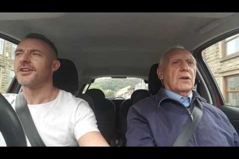 The Songaminute Man with his son, singing in their car